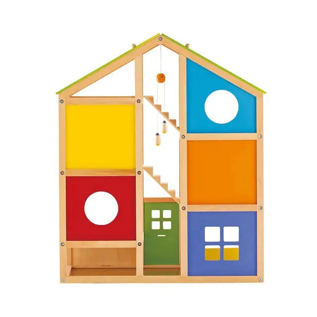 Rear view of the Hape E3401B All Seasons Wooden Dollhouse showing colorful wall panels, side openings and staircases