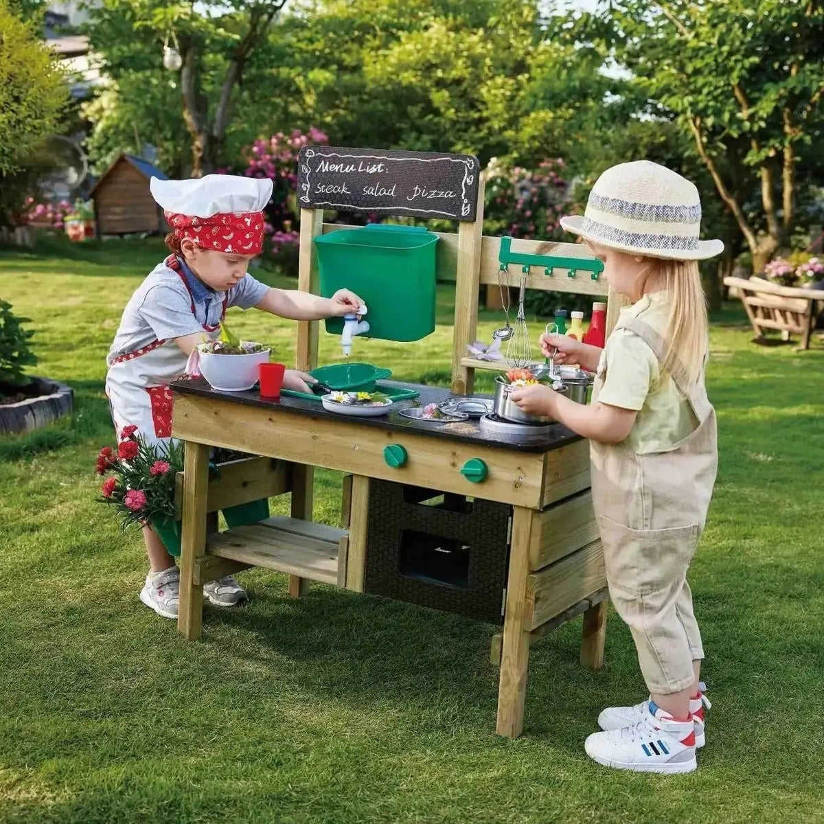 Two children enjoying pretend cooking and water play with the Hape wooden outdoor mud kitchen